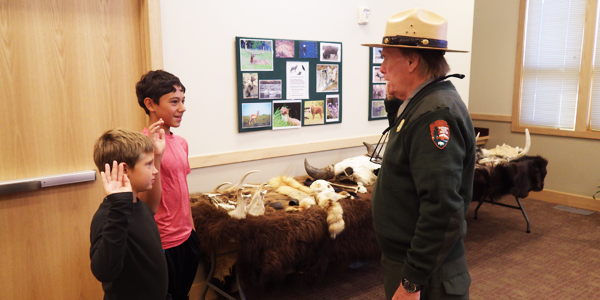 The boys receiving their Junior Ranger patches at Yellowstone Ranger Center