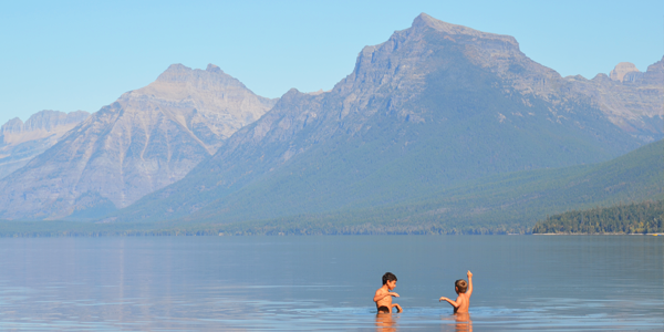 The boys take a swim in Mc Donald Lake at Glacier National Park